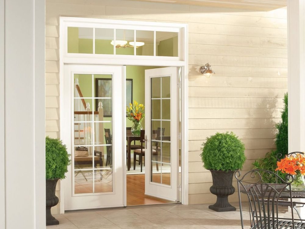 White French doors with grilles opening to a home interior.